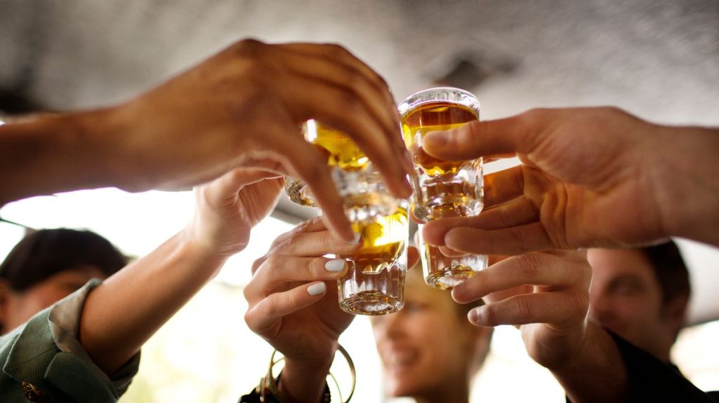 0 Friends enjoying tequila in bar