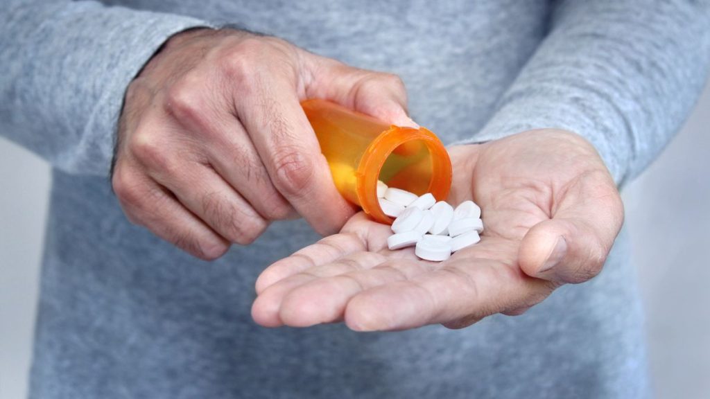 0 Man taking pills