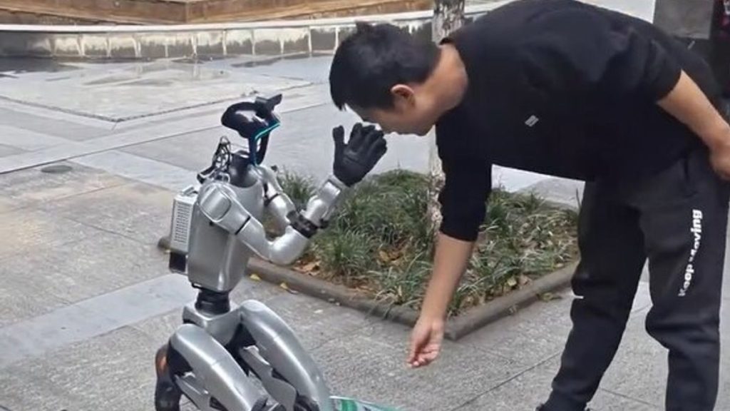Robot spotted begging for cash on its knees in street after hitting rock bot-tom 5 0 VIDEO Rock bot tom Bizarre moment ROBOT begs for cash in street
