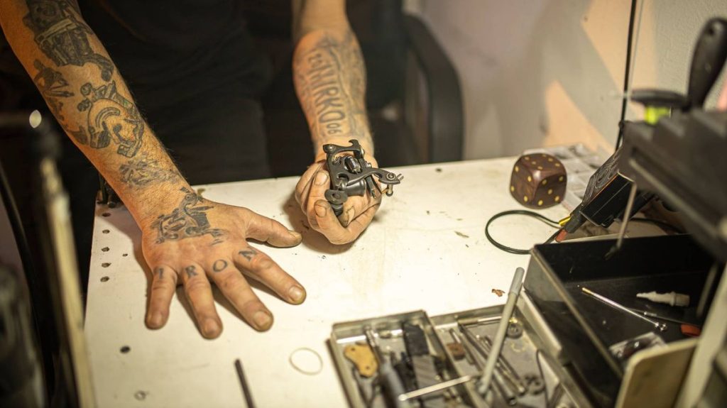 4 Tattoo artist observing a handmade tattoo machine