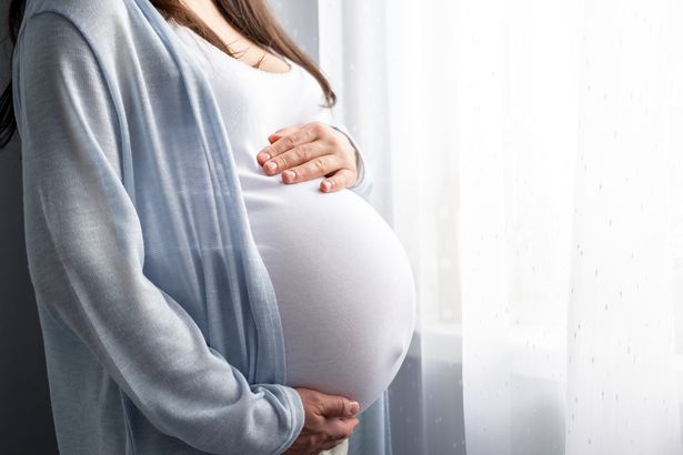 2 healthy pregnancy Side view pregnant woman with big belly advanced pregnancy in hands Banner copys